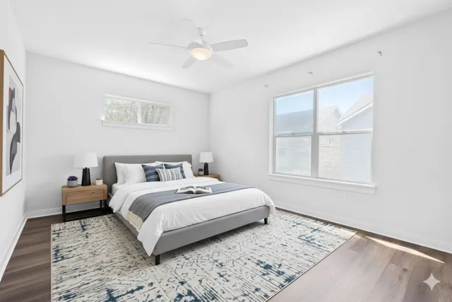 a bed room with a bed a couch and a window