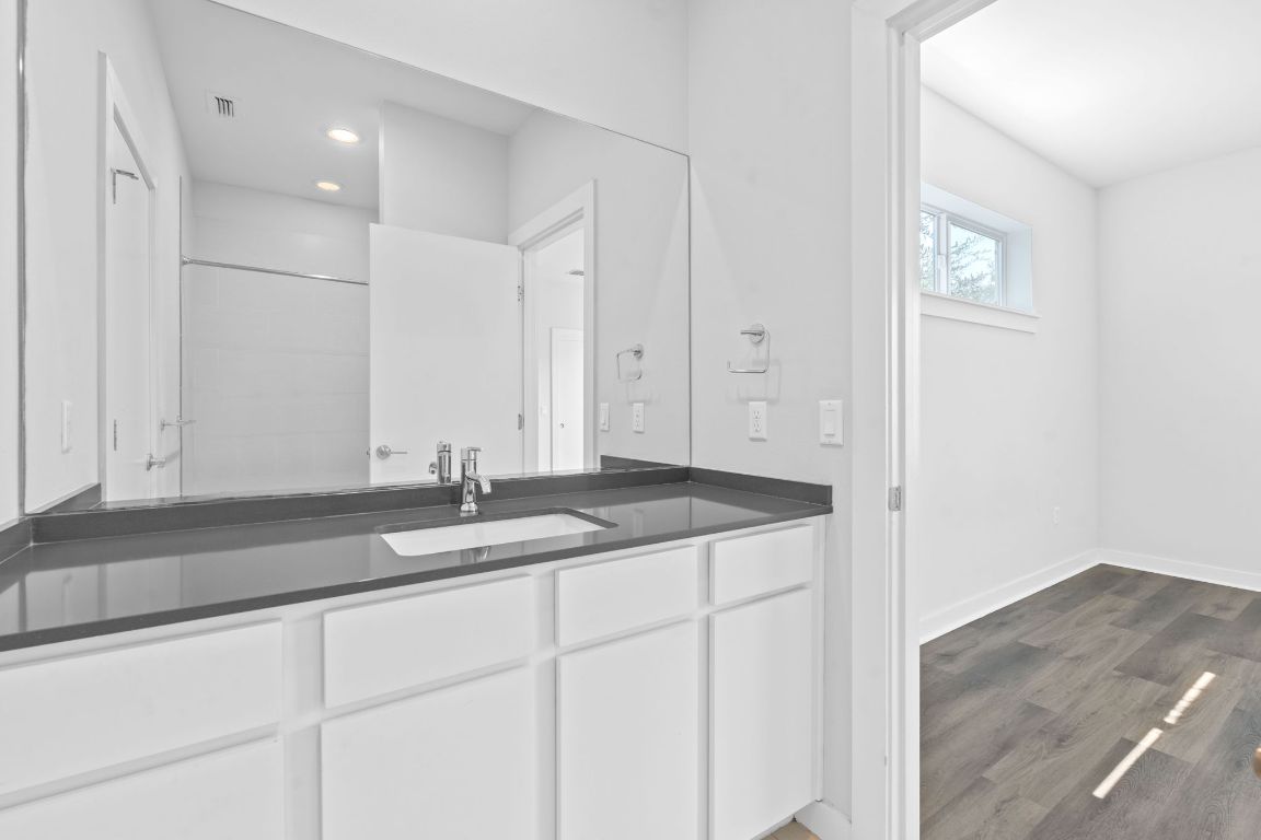 301 West Stassney Lane, Unit 7 Austin, TX 78745 - Photo 23 of 30 a bathroom with a granite countertop sink and mirror