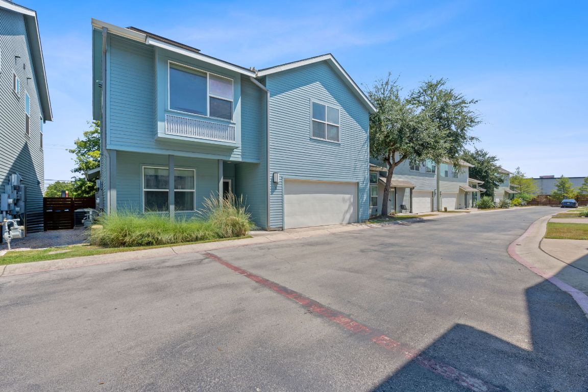 301 West Stassney Lane, Unit 7 Austin, TX 78745 - Photo 29 of 30 a front view of a house with a yard and garage