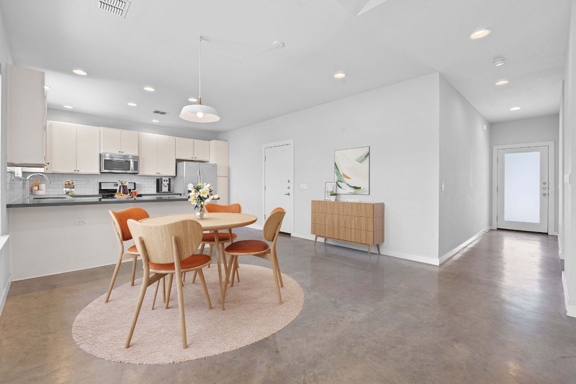 301 West Stassney Lane, Unit 7 Austin, TX 78745 - Photo 3 of 30 a view of a dining room with furniture and wooden floor