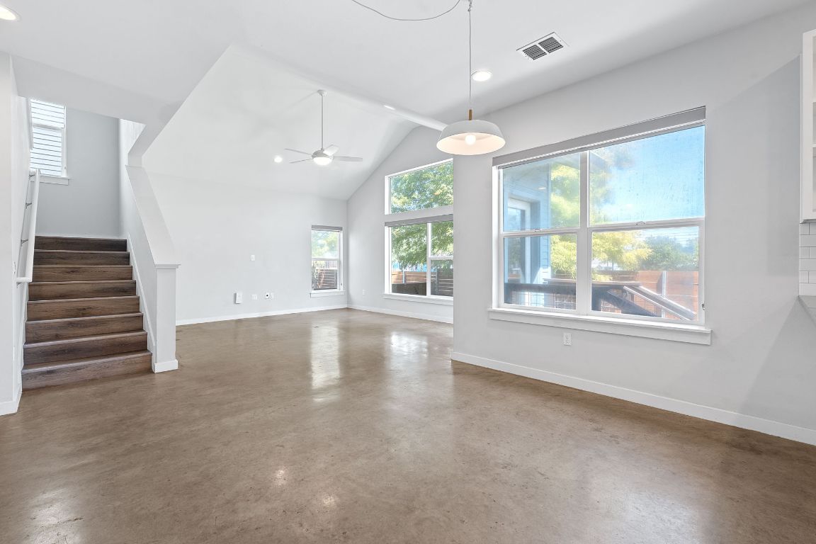 301 West Stassney Lane, Unit 7 Austin, TX 78745 - Photo 7 of 30 an empty room with wooden floor and windows