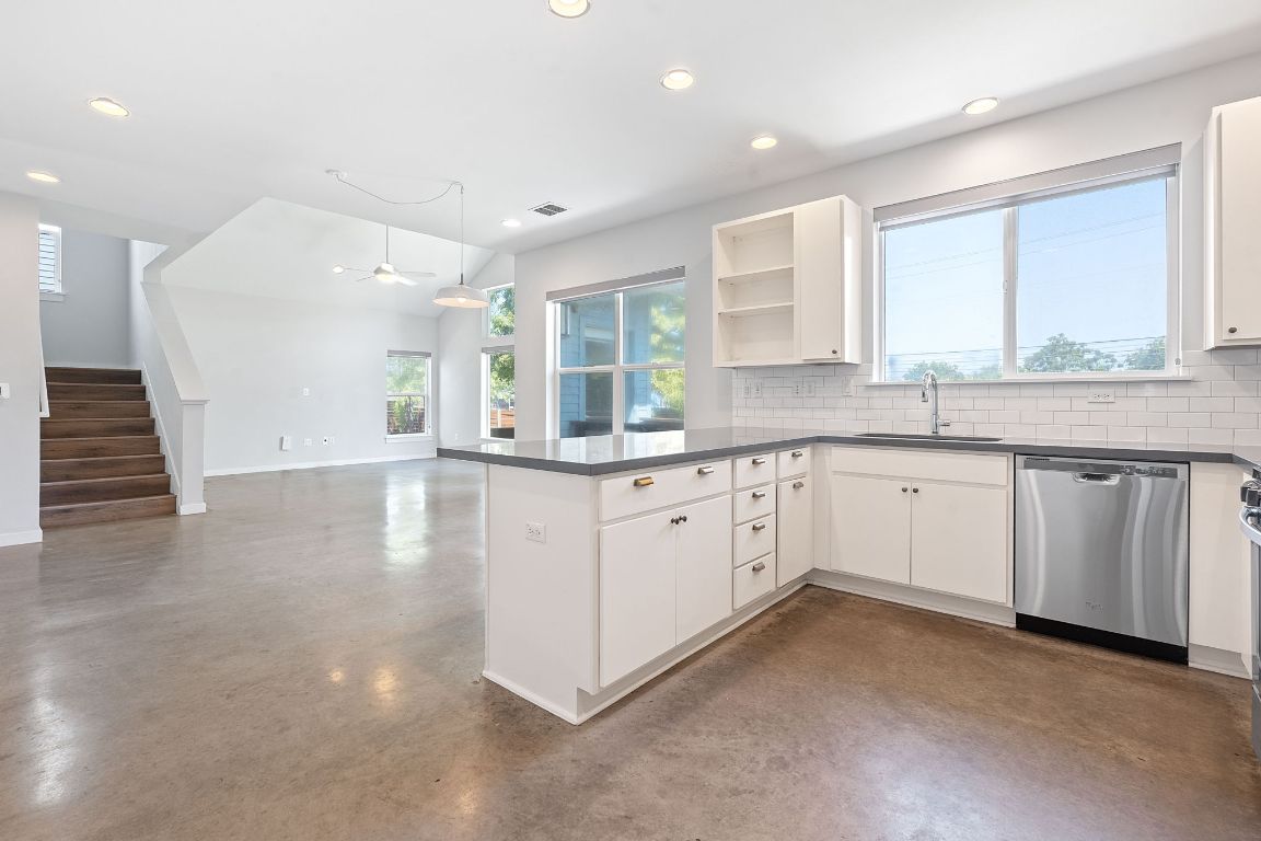 301 West Stassney Lane, Unit 7 Austin, TX 78745 - Photo 9 of 30 a kitchen with granite countertop white cabinets and white appliances