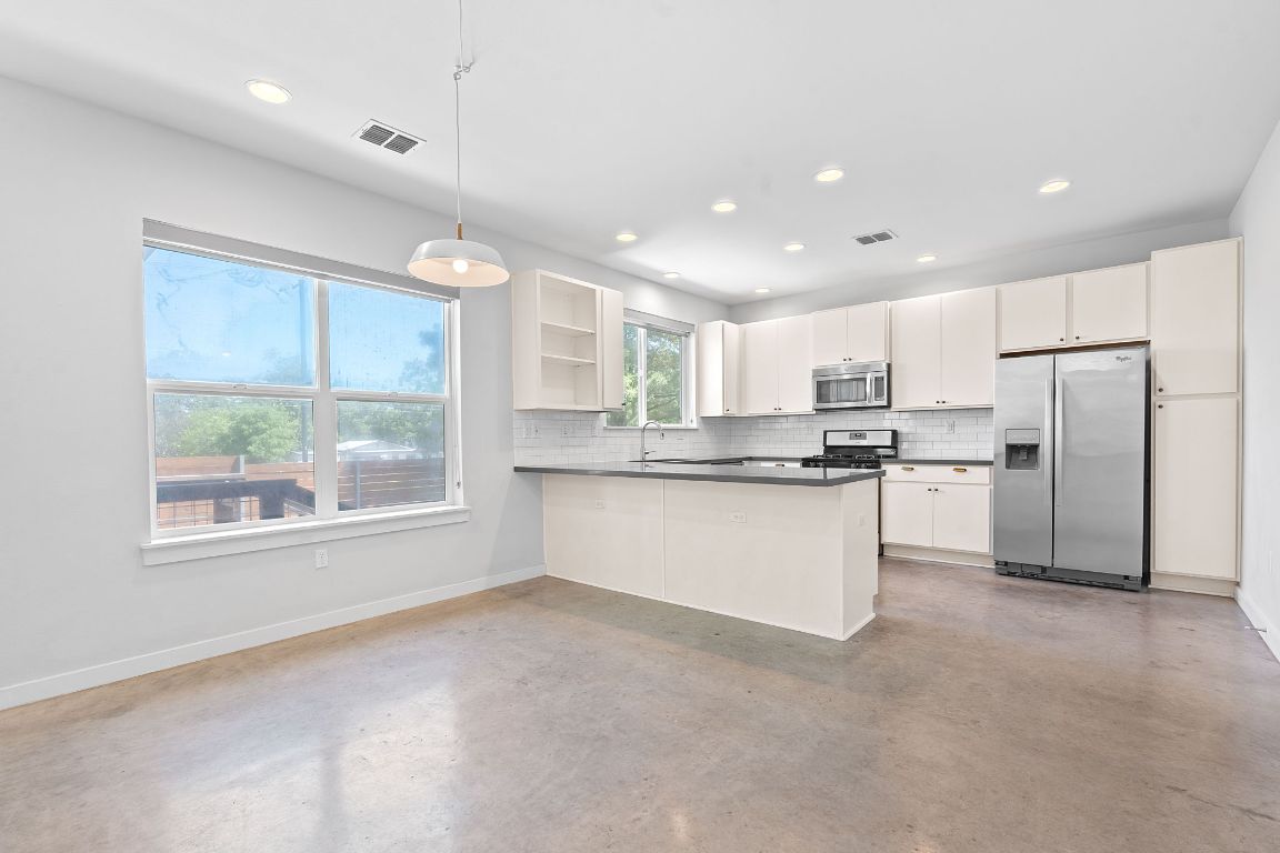 301 West Stassney Lane, Unit 7 Austin, TX 78745 - Photo 10 of 30 a large kitchen with cabinets and stainless steel appliances