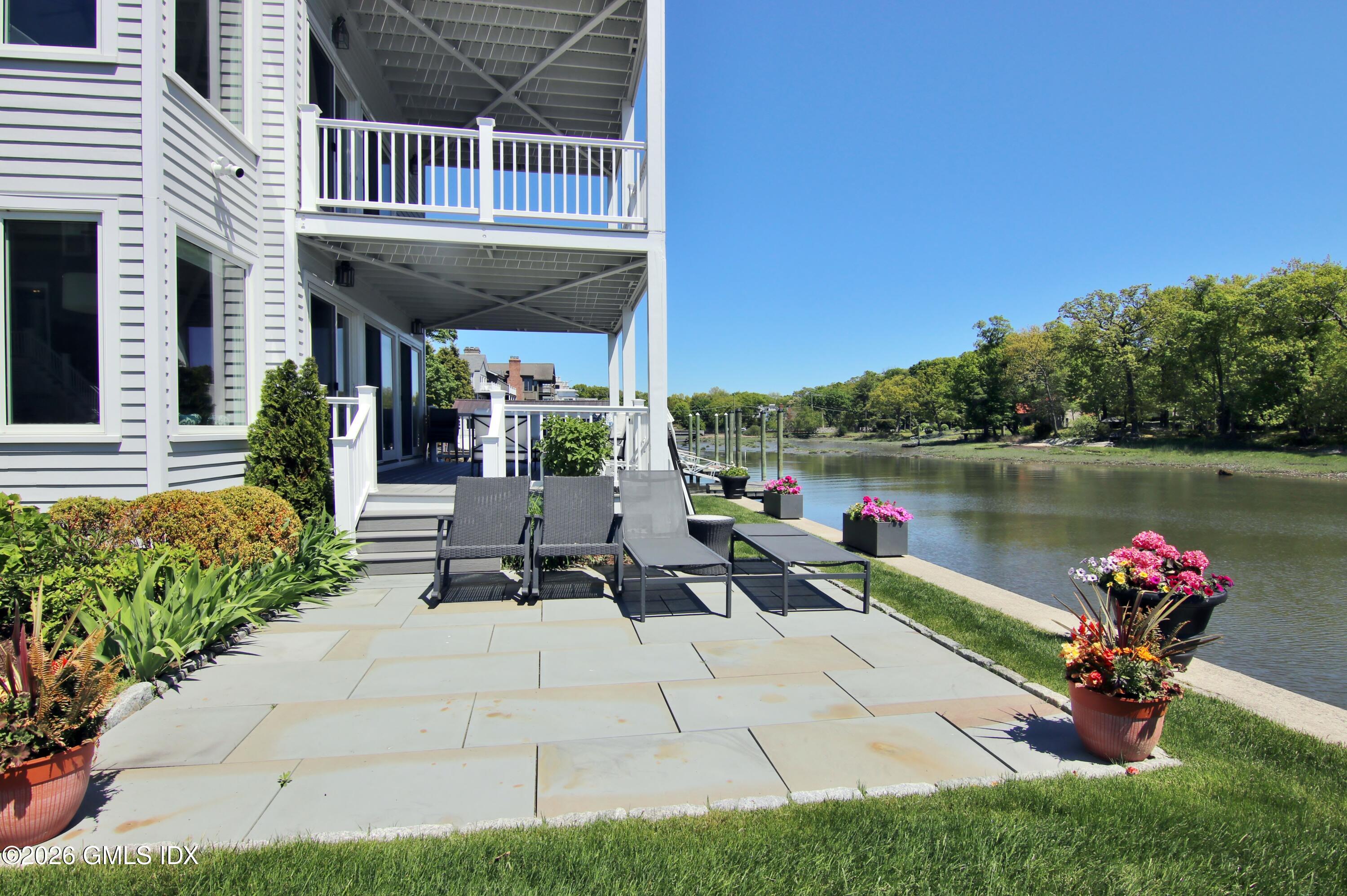 633 Steamboat Road, Unit 5 Greenwich, CT 06830 - Photo 5 of 29 a view of a swimming pool with a patio and a garden