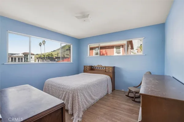 a bedroom with two beds and a desk
