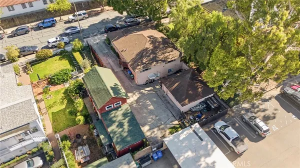 an aerial view of a house with a yard and garden