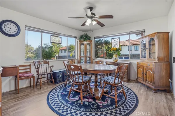 a view of a dining room with furniture window and wooden floor