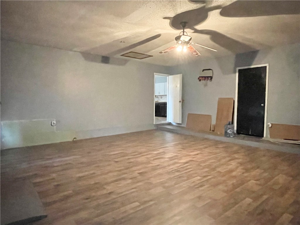 133 Wayman Drive Whitney, TX 76692 - Photo 15 of 38 en empty room with windows and ceiling fan