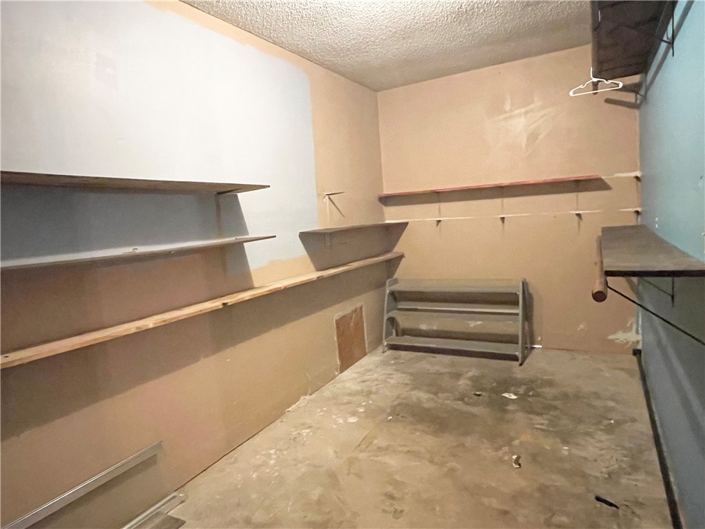 133 Wayman Drive Whitney, TX 76692 - Photo 16 of 38 a view of walk in closet with empty racks
