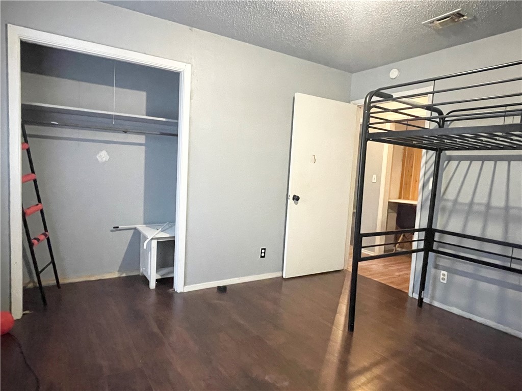 133 Wayman Drive Whitney, TX 76692 - Photo 21 of 38 a view of an empty room with wooden floor and a window