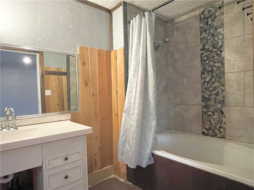 133 Wayman Drive Whitney, TX 76692 - Photo 24 of 38 a bathroom with a bathtub a sink and a shower
