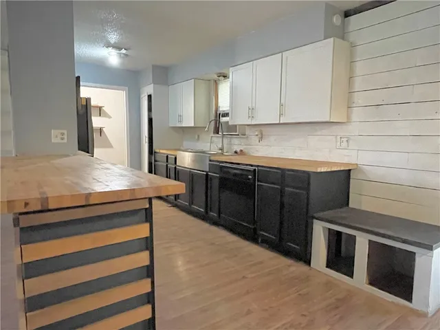 a kitchen with stainless steel appliances granite countertop a sink stove and cabinets