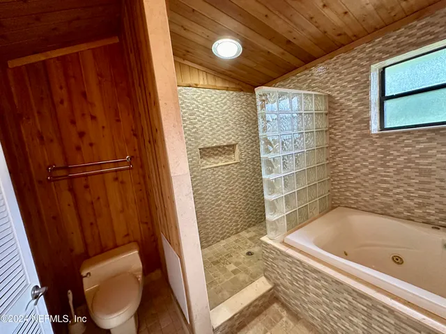 a bathroom with a bathtub and toilet