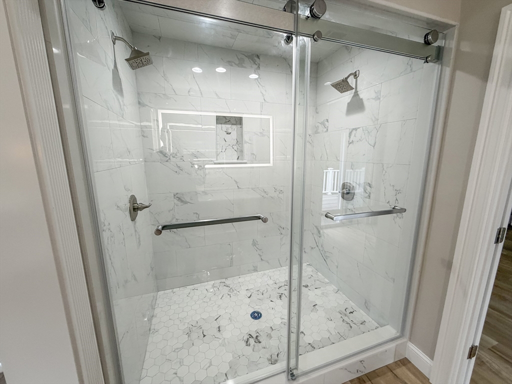 1132 West Boylston Street, Unit 2 Worcester, MA 01606 - Photo 19 of 42 a bathroom with a glass shower door and a sink