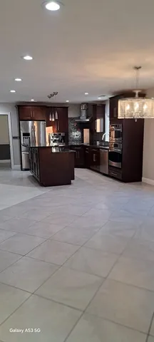 a view of an empty room with kitchen appliances