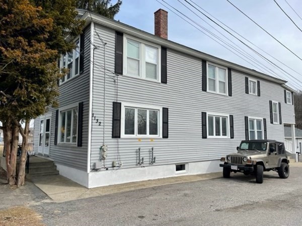 1132 West Boylston Street, Unit 2 Worcester, MA 01606 - Photo 28 of 42 a car parked in front of a house