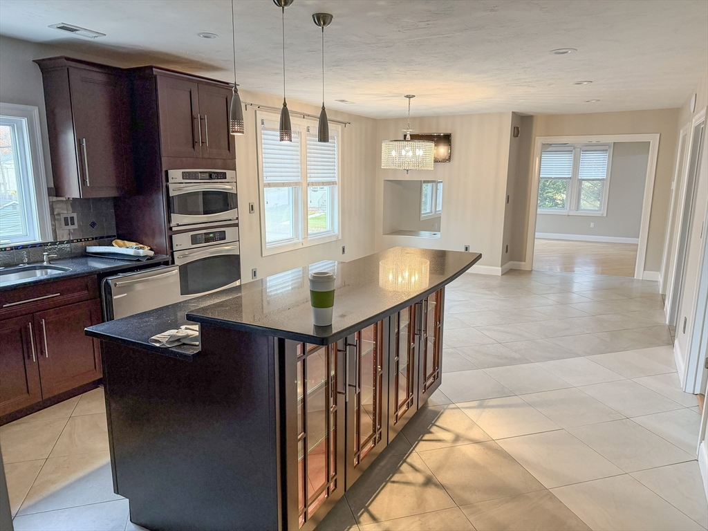 1132 West Boylston Street, Unit 2 Worcester, MA 01606 - Photo 3 of 42 a kitchen with stainless steel appliances granite countertop a refrigerator a sink and wooden cabinets