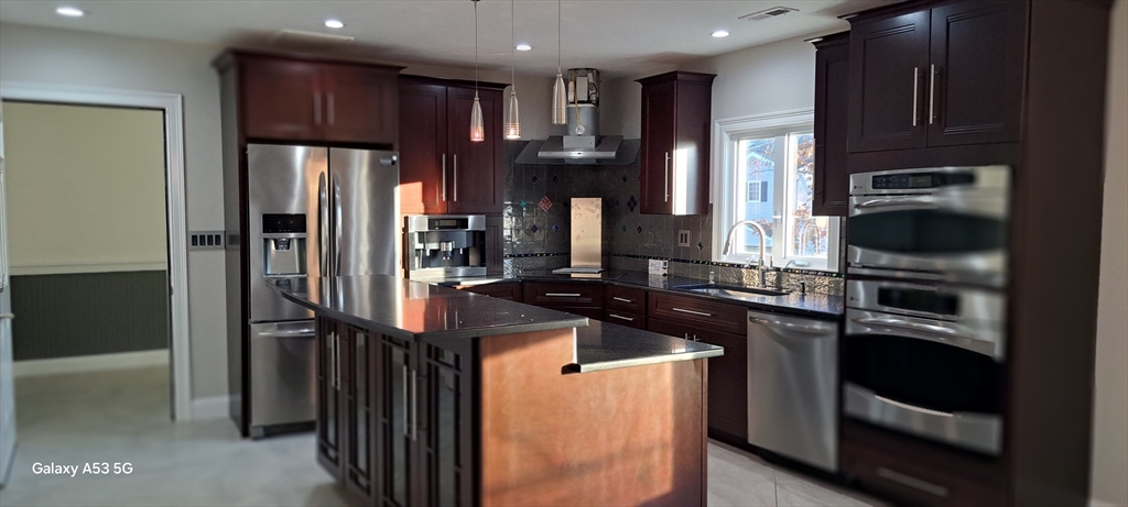 1132 West Boylston Street, Unit 2 Worcester, MA 01606 - Photo 31 of 42 a kitchen with stainless steel appliances granite countertop a refrigerator and a stove