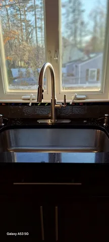 a bathroom with a granite countertop sink a toilet and bathtub
