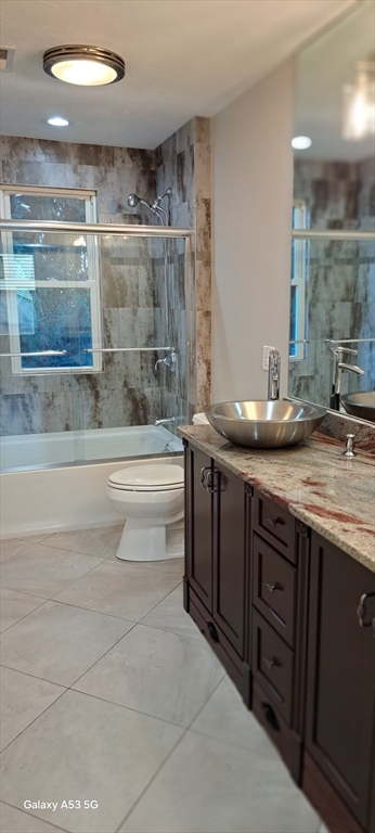 1132 West Boylston Street, Unit 2 Worcester, MA 01606 - Photo 39 of 42 a bathroom with a granite countertop sink a toilet and bathtub