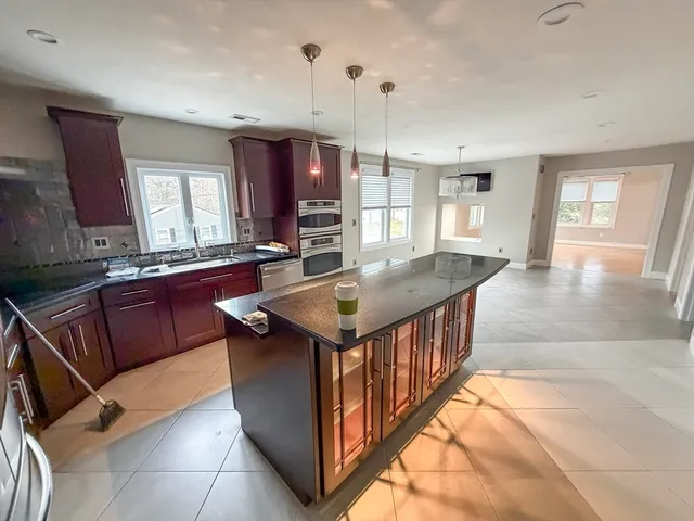 a kitchen with stainless steel appliances granite countertop a sink stove and cabinets