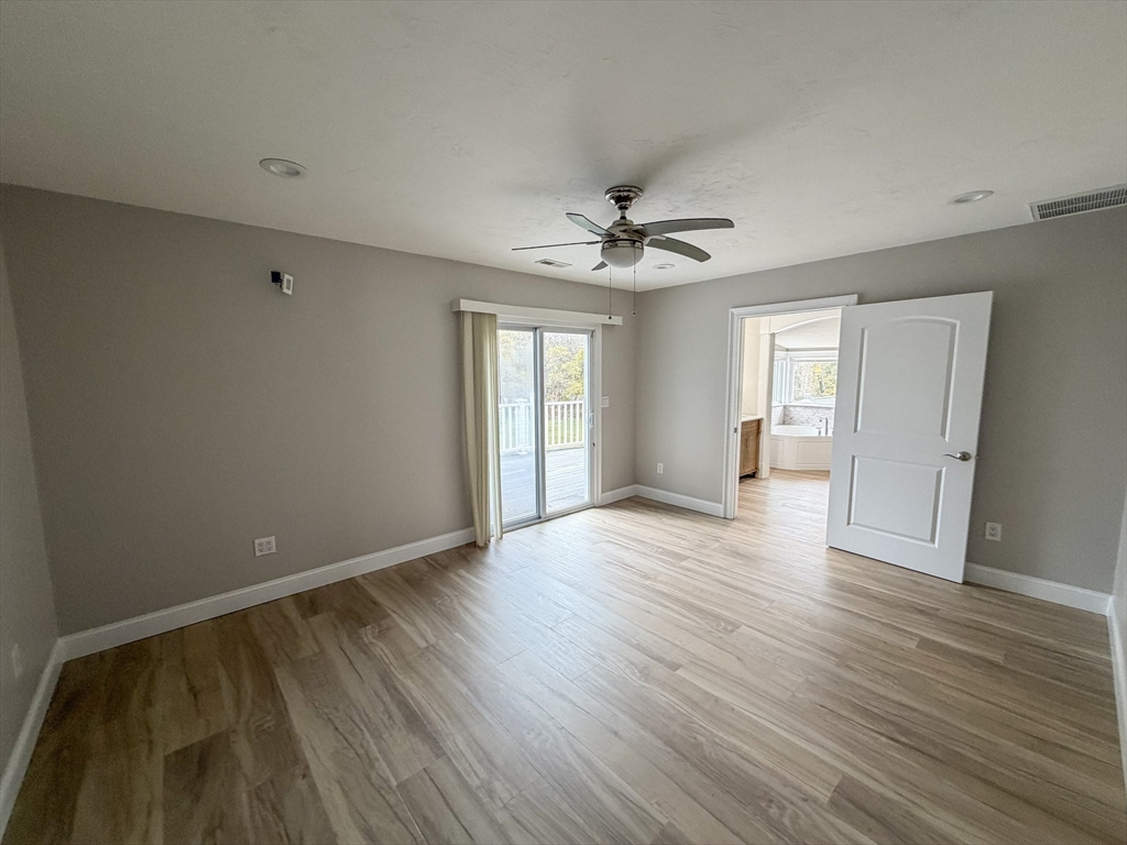 1132 West Boylston Street, Unit 2 Worcester, MA 01606 - Photo 9 of 42 a view of an empty room with wooden floor and a window