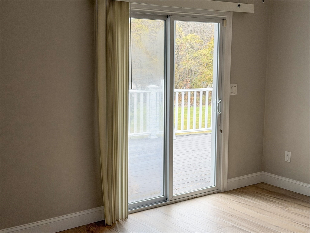 1132 West Boylston Street, Unit 2 Worcester, MA 01606 - Photo 10 of 42 a view of an empty room with wooden floor and a window