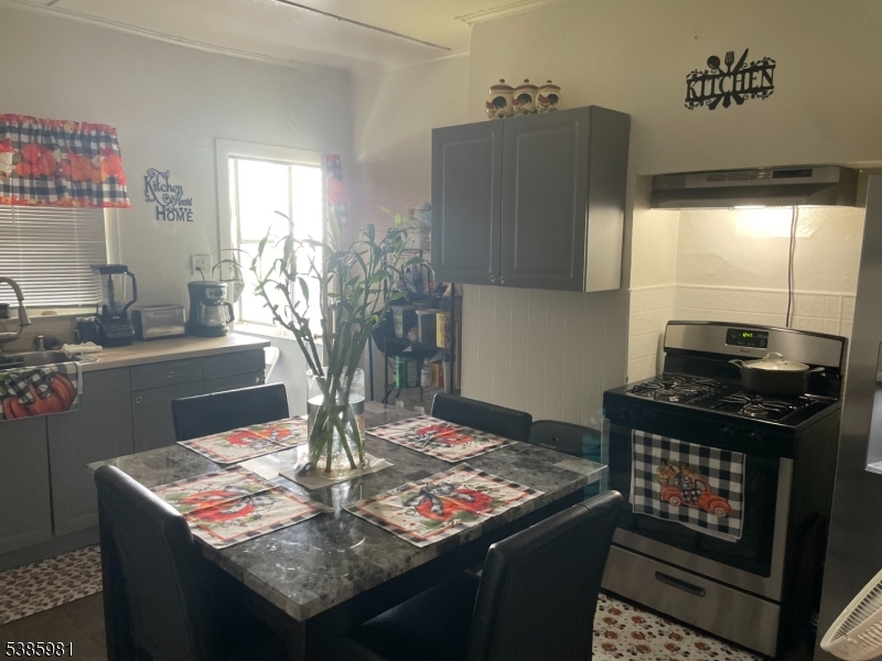 63 Front Street Paterson, NJ 07522 - Photo 12 of 17 a kitchen with a stove and a refrigerator