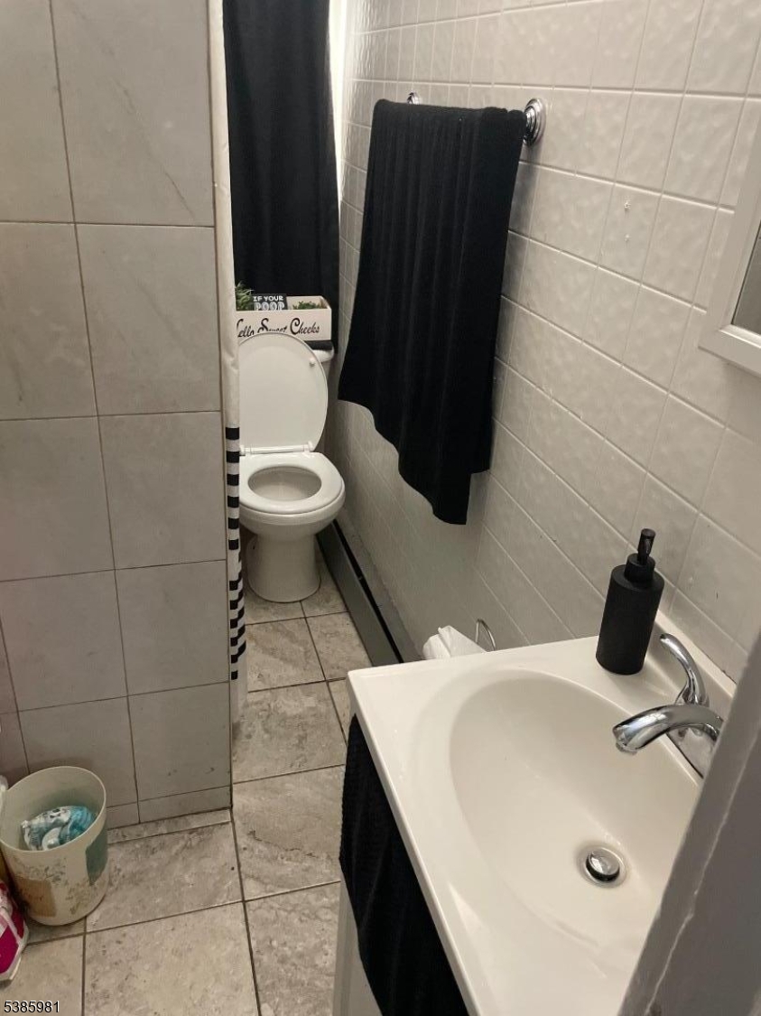 63 Front Street Paterson, NJ 07522 - Photo 13 of 17 a bathroom with a sink and a toilet