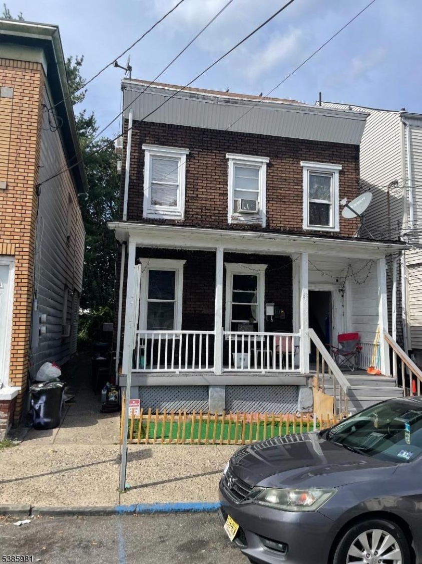 63 Front Street Paterson, NJ 07522 - Photo 17 of 17 a view of a house with a wooden deck
