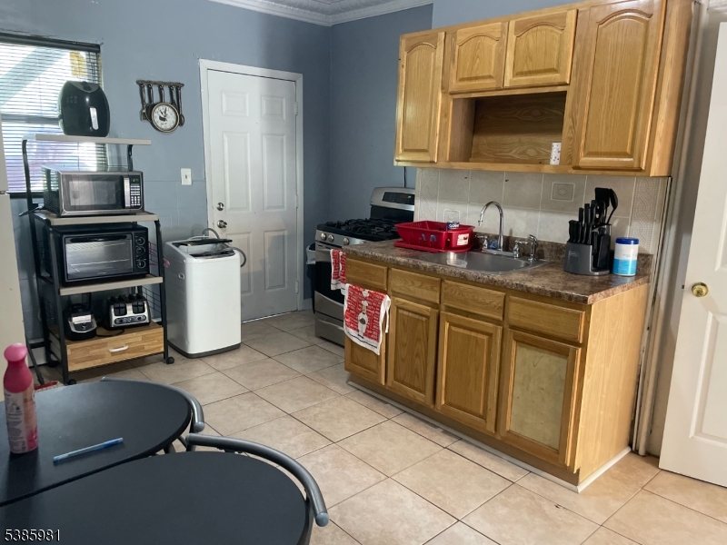 63 Front Street Paterson, NJ 07522 - Photo 5 of 17 a kitchen with stainless steel appliances granite countertop a sink dishwasher stove and refrigerator