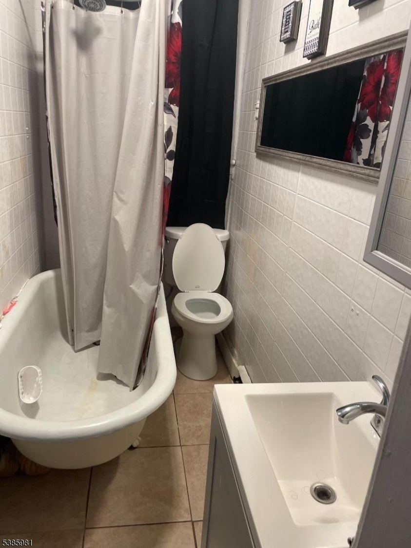 63 Front Street Paterson, NJ 07522 - Photo 6 of 17 a bathroom with a sink and a toilet