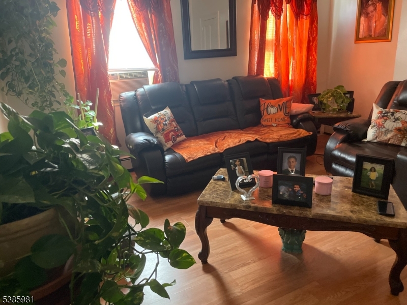 63 Front Street Paterson, NJ 07522 - Photo 7 of 17 a living room with furniture and a potted plant