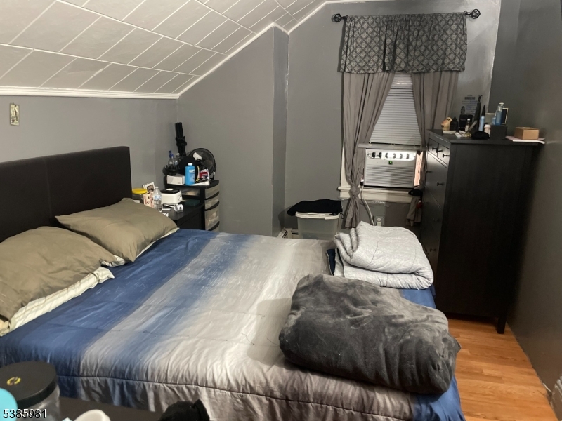 63 Front Street Paterson, NJ 07522 - Photo 8 of 17 a bedroom with a bed and wooden floor