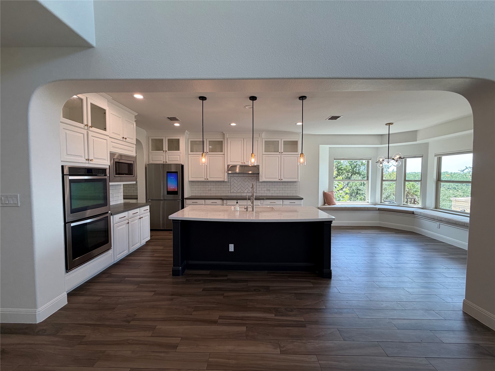 7801 Aria Loop Austin, TX 78736 - Photo 8 of 40 A large Island with dramatic Iron Ore Cabinetry and counter height bar Overlooks Great Room
