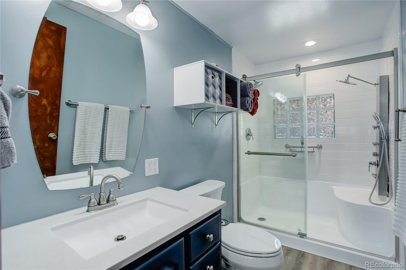 19285 Fox Den Way Morrison, CO 80465 - Photo 13 of 24 a bathroom with a sink toilet and shower