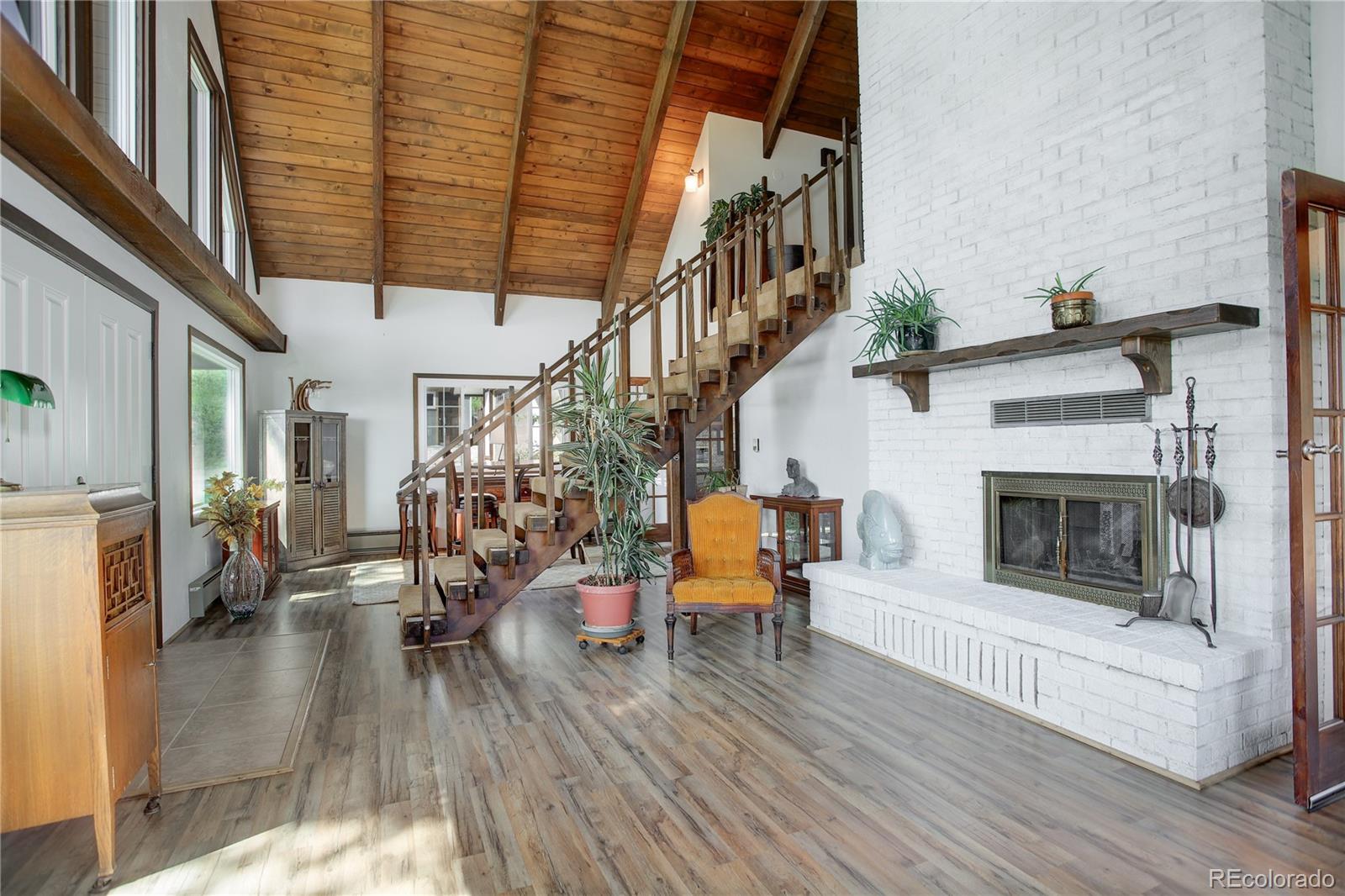 19285 Fox Den Way Morrison, CO 80465 - Photo 16 of 24 a living room with furniture and a fireplace