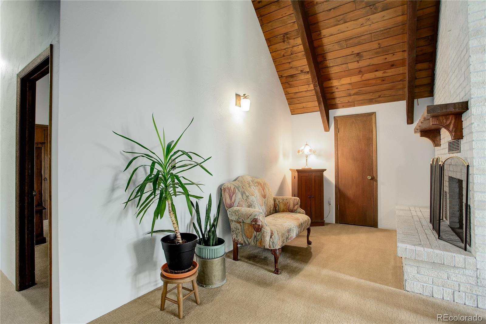 19285 Fox Den Way Morrison, CO 80465 - Photo 17 of 24 a living room with furniture and a potted plant