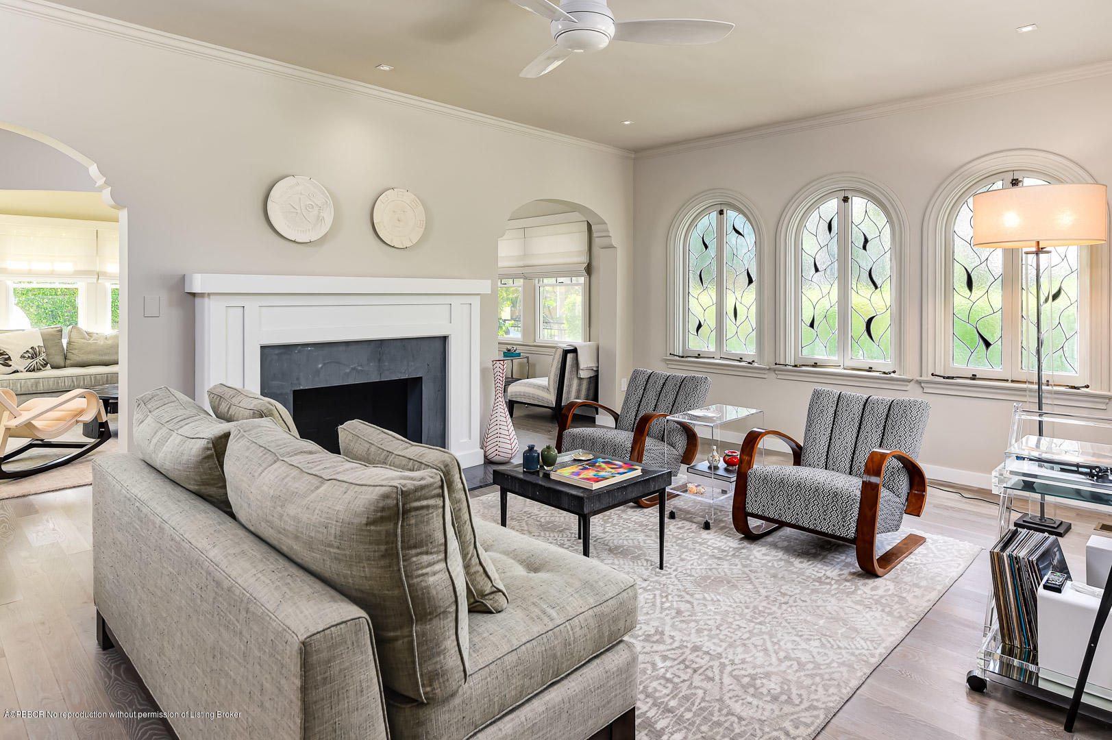 a living room with furniture fireplace and a large window