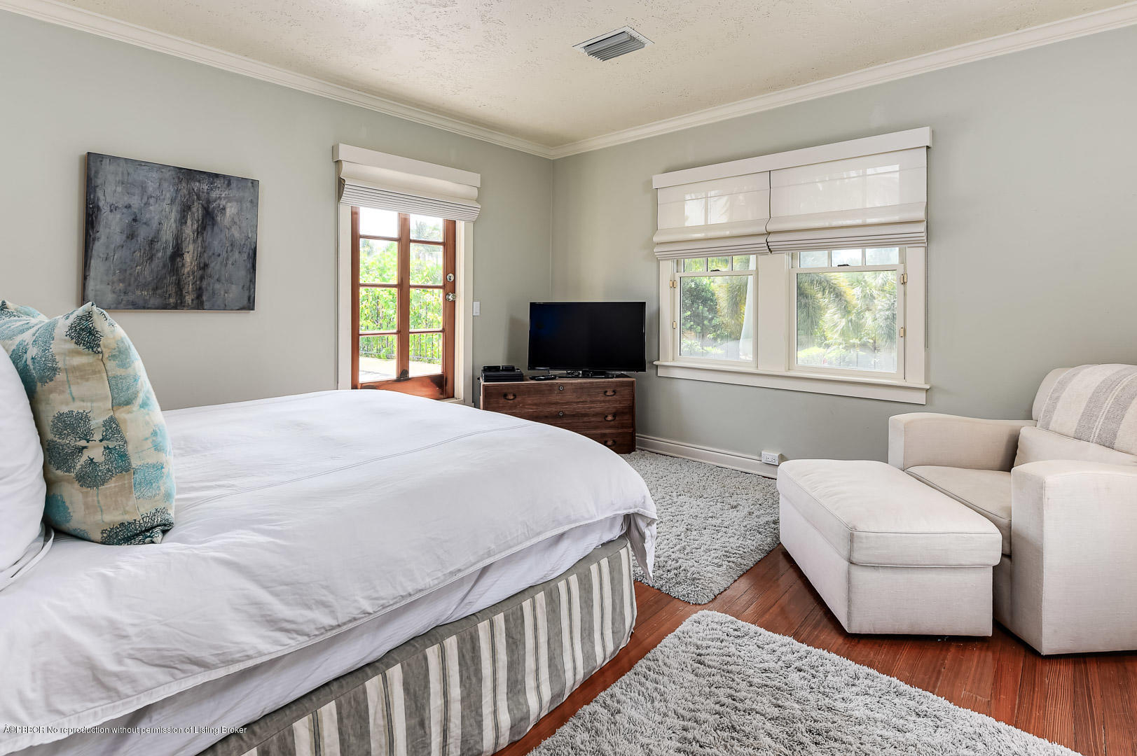 283 Valencia Road West Palm Beach, FL 33401 - Photo 15 of 23 a bedroom with a bed a couch and a window with wooden floor