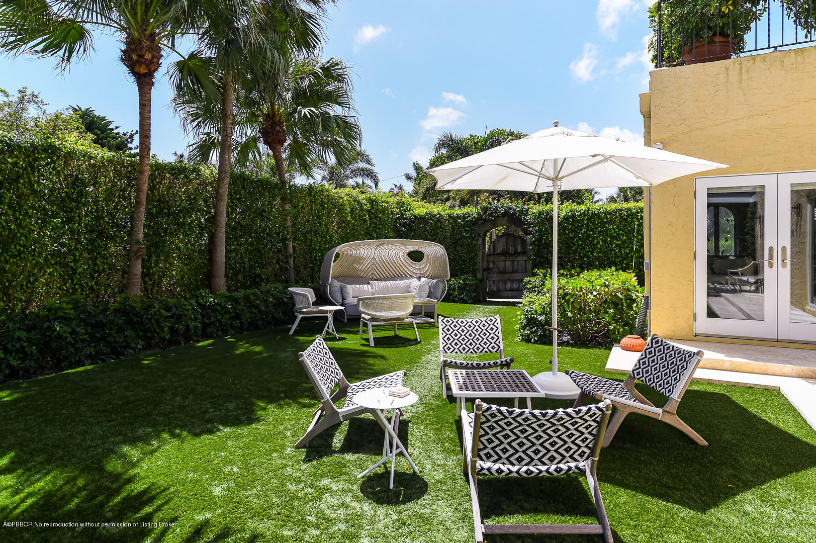 283 Valencia Road West Palm Beach, FL 33401 - Photo 20 of 23 a view of a chairs and table in backyard of the house