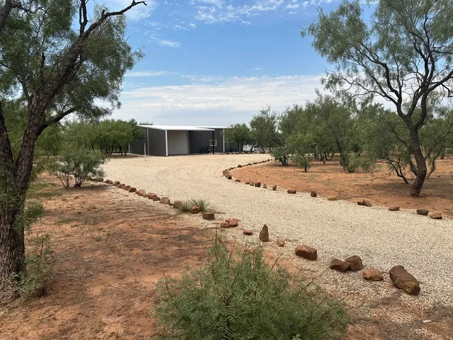 a view of a yard with snow on the road