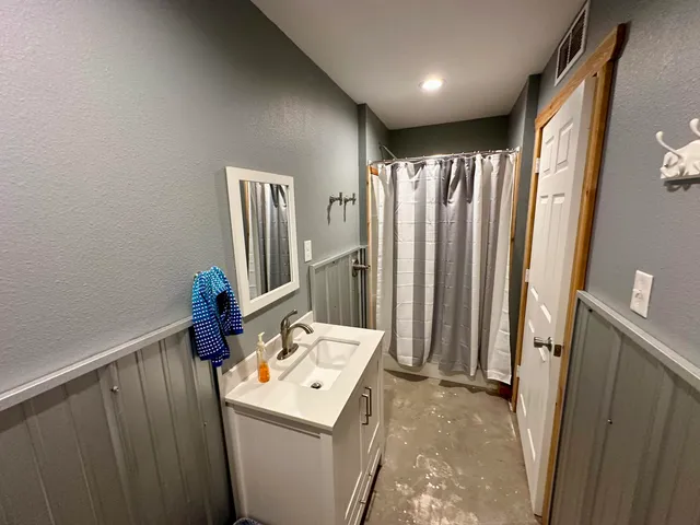 a view of a terrace with wooden floor and a ocean view