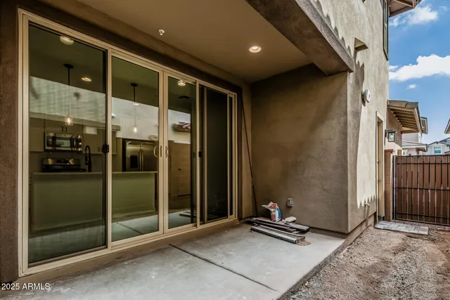 an empty room with ceiling fan and window