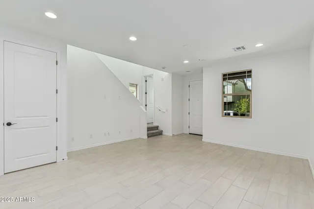a view of an empty room with a kitchen
