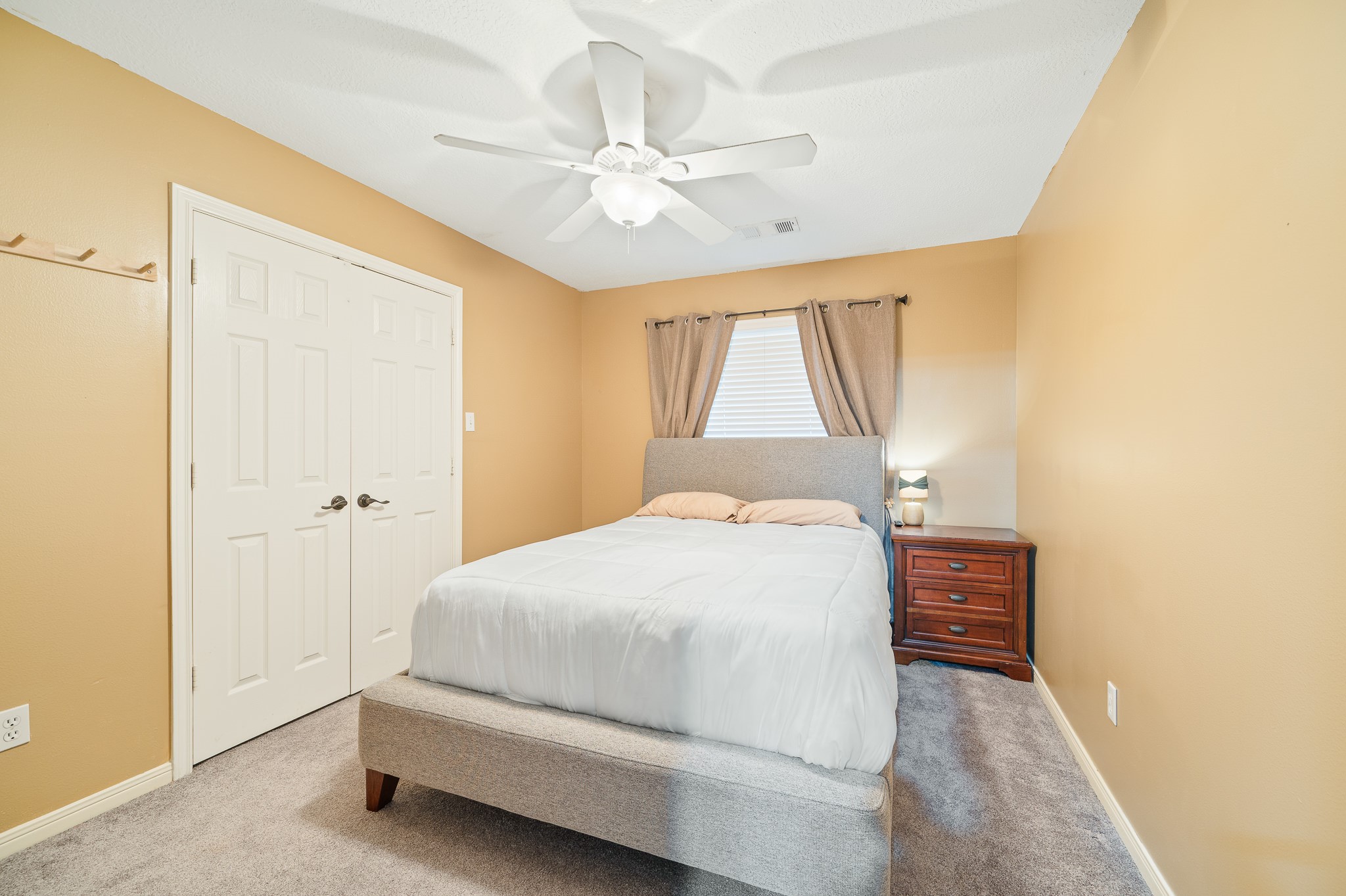8111 Morningbrook Court Spring, TX 77379 - Photo 36 of 46 a bedroom with a bed and a chandelier