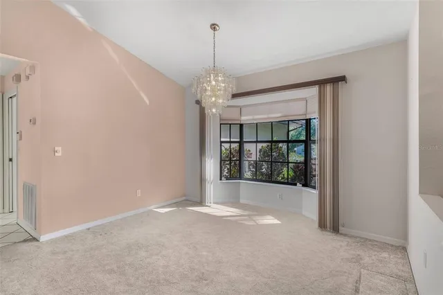a kitchen with stainless steel appliances a sink cabinets and a chandelier