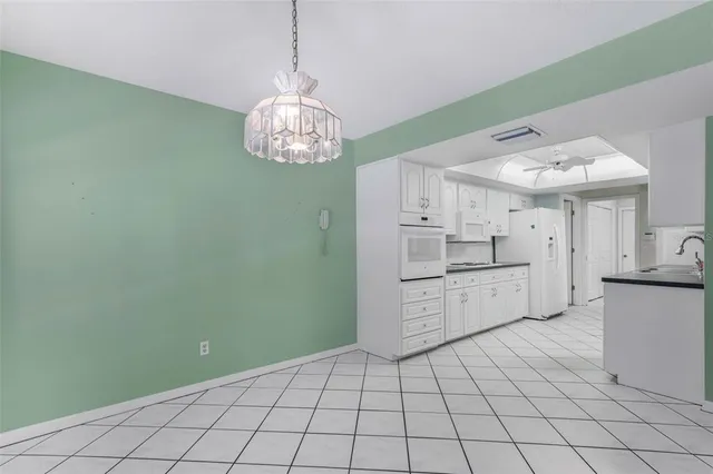 a view of a kitchen with a sink and cabinets
