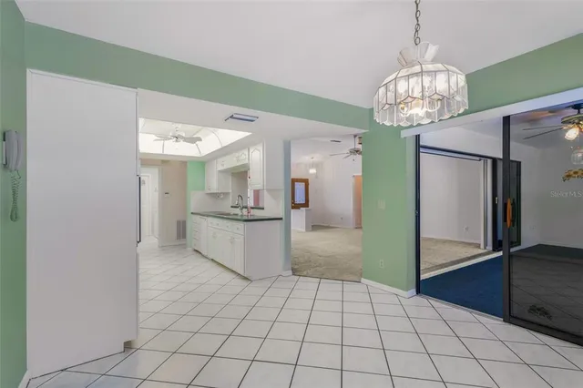 a kitchen with granite countertop white cabinets and white appliances