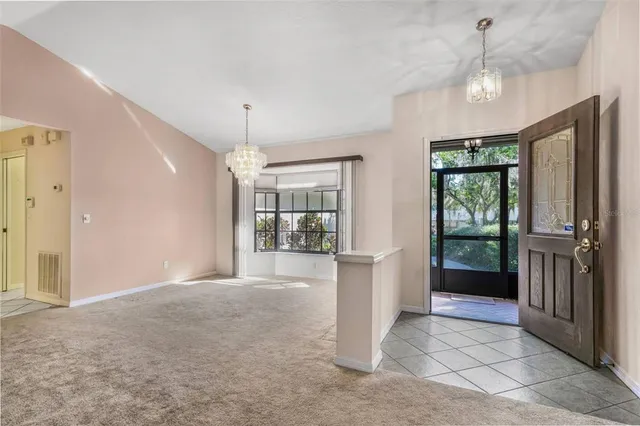 a view of an empty room with window and cabinet